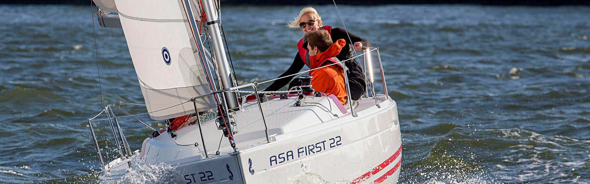 Man and woman enjoying sailing lessons from American Sailing Association