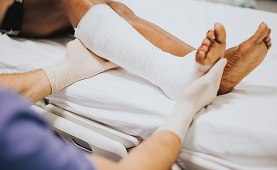 woman in ER with bandaged leg