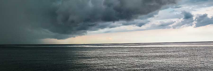 storm clouds and rain over the ocean