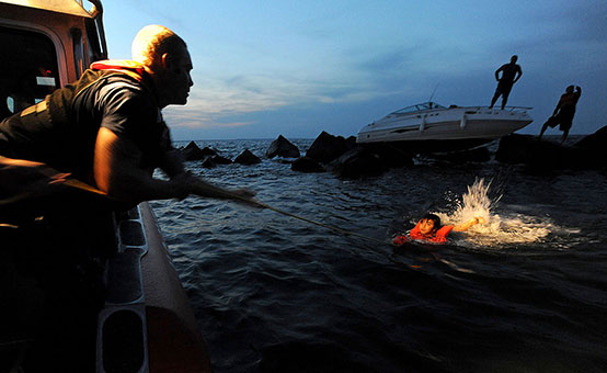 The US Coast Guard rescues an injured family after their boat accidentally runs aground.