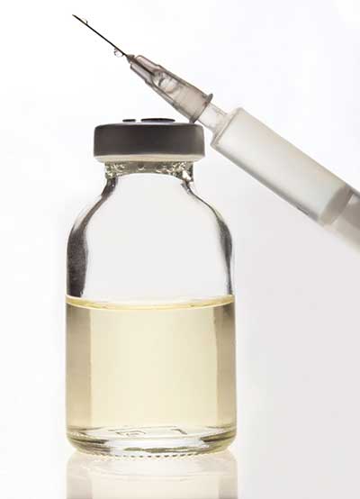 syringe and bottle of antivenom