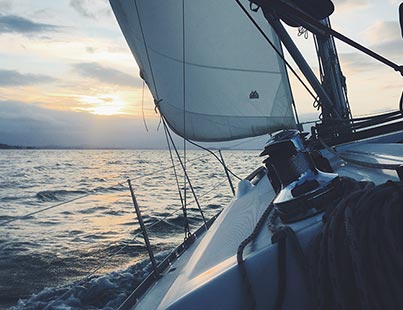 sailing into approaching storm clouds at sunset