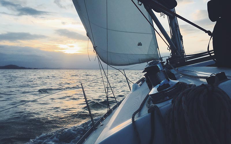 sailing into approaching storm clouds at sunset