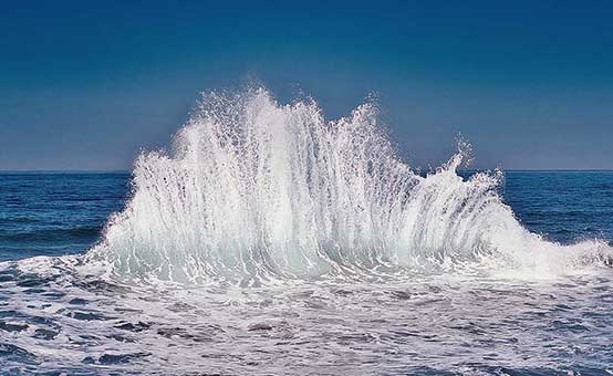 large ocean wave crashing on the sea