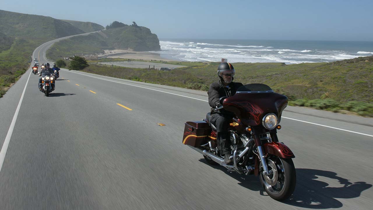 motorcycle riders cruising seaside