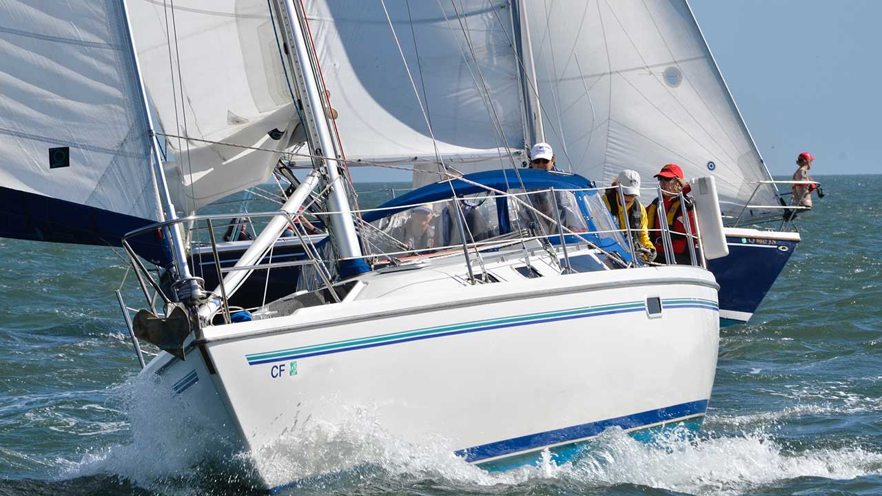 students wear life jackets for safety while taking a sailing course