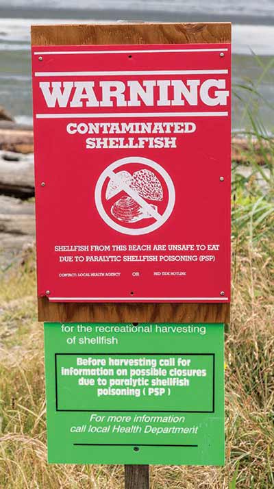 beach warning sign about paralytic shellfish poisoning