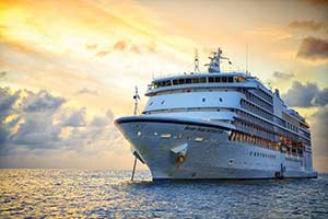 cruise ship sailing at sunset