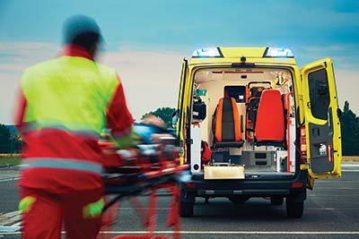 EMS paramedic provides medevac for a victim on a stretcher