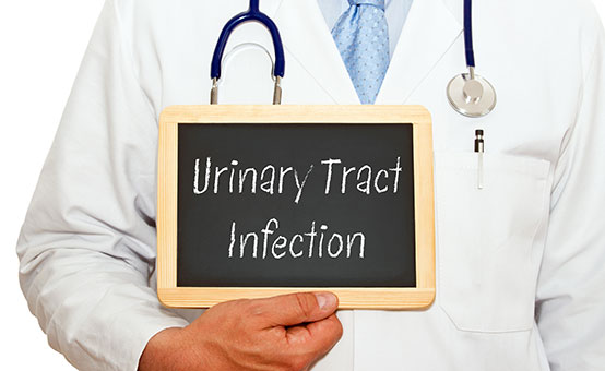 doctor holding a chalkboard with the phrase urinary tract infection uti