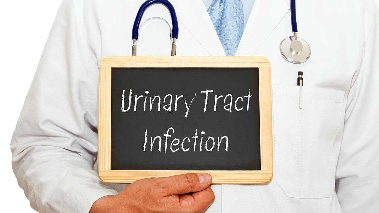 doctor holding a chalkboard with the phrase urinary tract infection uti