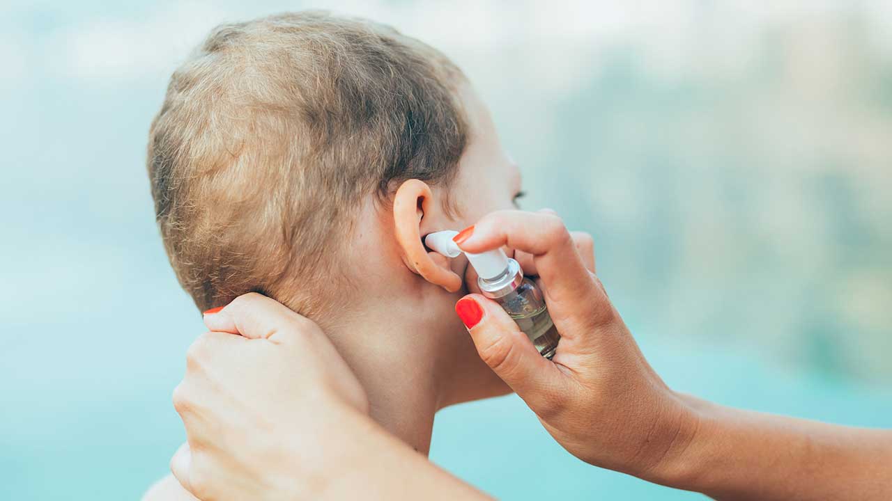 young boy eardrops swimmers ear